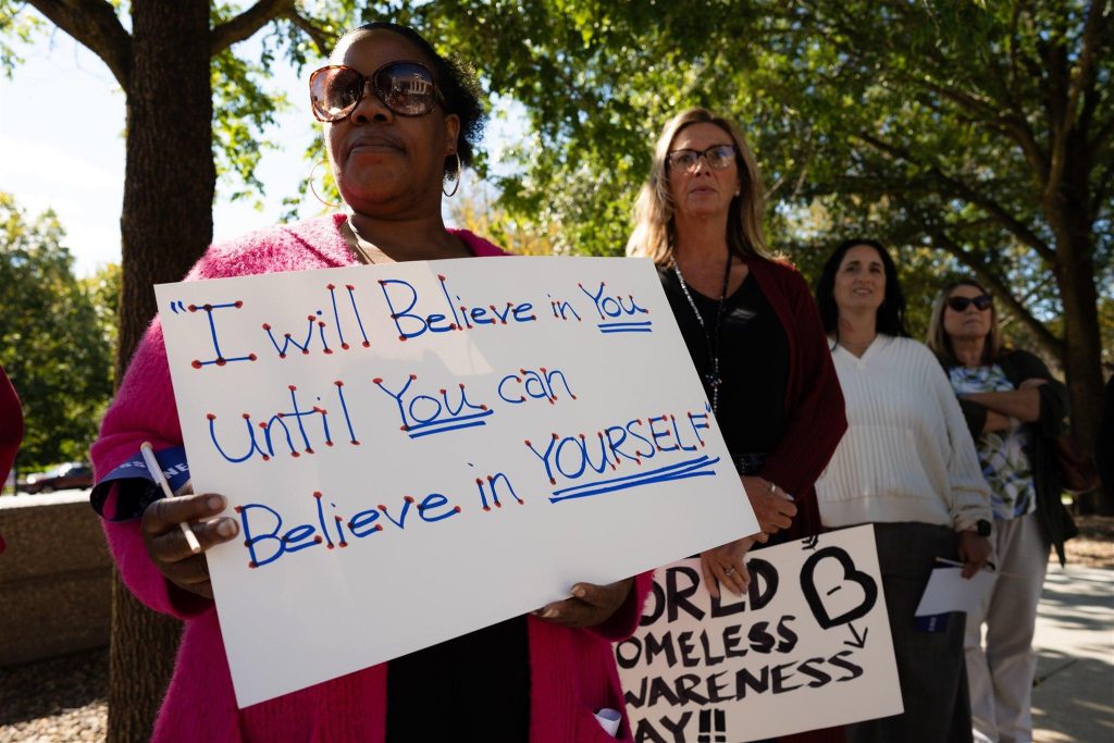 Community members holding signs of encouragement during a Cornerstone of Beaver County awareness event, reflecting the organization's mission of hope, dignity, and support.